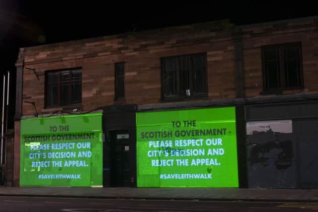 Several messages calling for urgent action from the Scottish Government were projected on to the vacant shop fronts at Steads Place