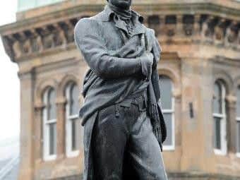 The Robert Burns statue sporting a pair of stripey socks put on by a local resident. Picture: Lesley Martin.