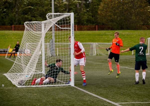 Edinburgh University's Daniel McBeth scores an own goal during the 3-1 defeat by Broxburn Athletic. Pic: TSPL