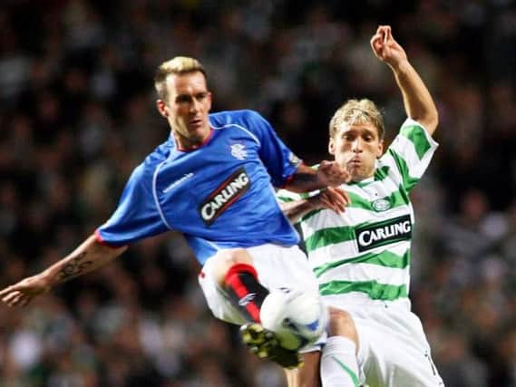 Celtic midfielder Stiliyan Petrov, right, battles for the ball with Rangers' Fernando Ricksen during the CIS Cup quarter-final clash between the two sides in November 2005