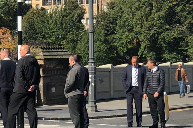 Drivers examining a 'super bus' going around the Market Street and Waverley Bridge roundabout