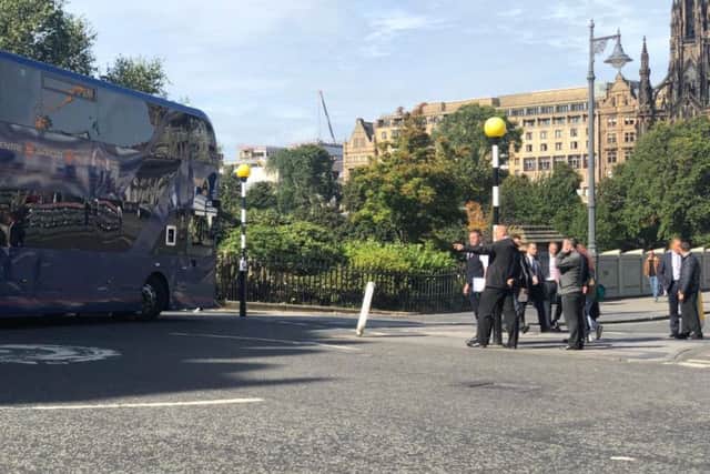 Drivers examining a 'super bus' going around the Market Street and Waverley Bridge roundabout
