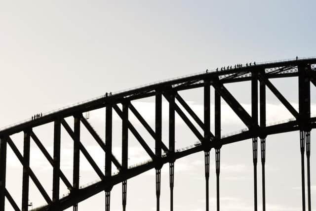 People take a walking tour on Sydney Harbour Bridge.