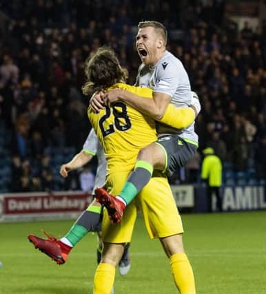 Josh Vela leaps on Chris Maxwell after Hibs secured a Betfred Cup semi-final place