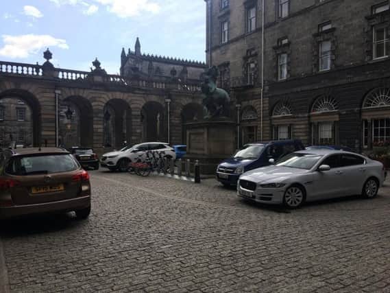 Cars often clutter the City Chambers quadrangle on the high Street