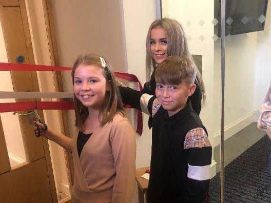 Mr Curries three children, Neve, 16 Max, 13 and Hana, 11 cut the ribbon to officially open the suite under its new name.