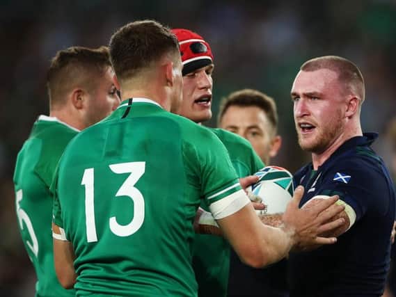 A frustrated Stuart Hogg exchanges words with Ireland centre Garry Ringrose during the 27-3 loss in Yokohama. Picture: Getty Images