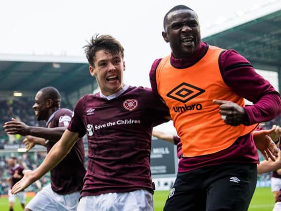 Aaron Hickey celebrates the Hearts winners with Clevid Dikamona. Picture: SNS