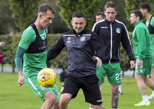 Hibs boss Paul Heckingbottom gets stuck in at training. Pic: SNS