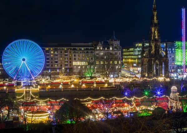 A long exposure photograph captures Scott Monument along side the 60 metre high Sky Flyer fairground ride which lights up Edinburgh's Christmas skyline in Princes Street Gardens. (Picture: SWNS)