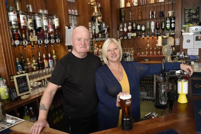 Jim and Jackie Colvine behind the bar at Iona Bar in Easter Road