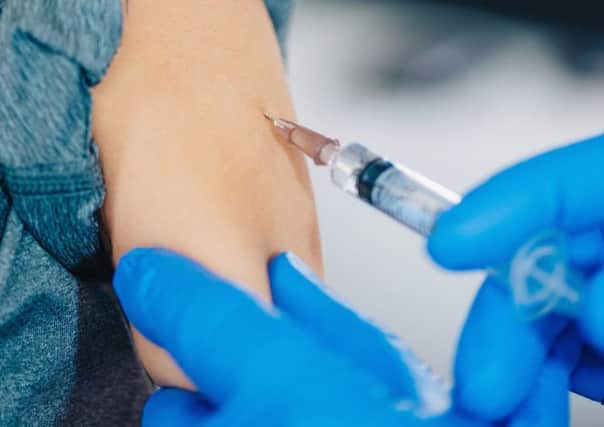 A Scottish child receives a vaccine