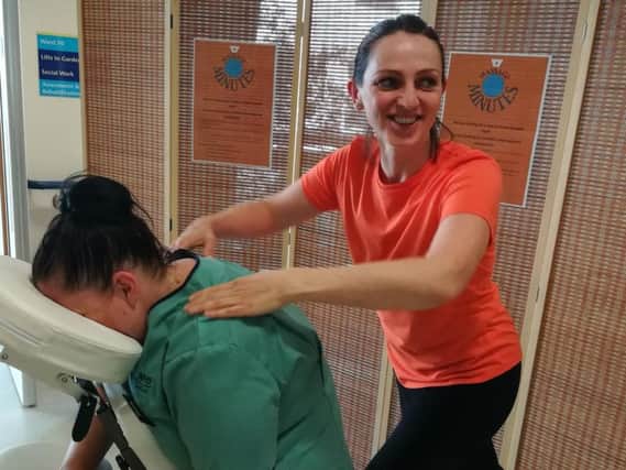 Juliet Barton gives a nurse a massage.