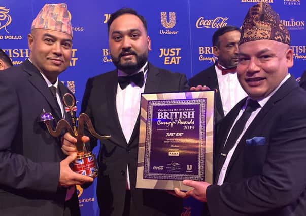 Radhuni staff celebrate their British Curry Awards success. Rajesh Karki with Ashok Ram and Habibur Khan (centre).