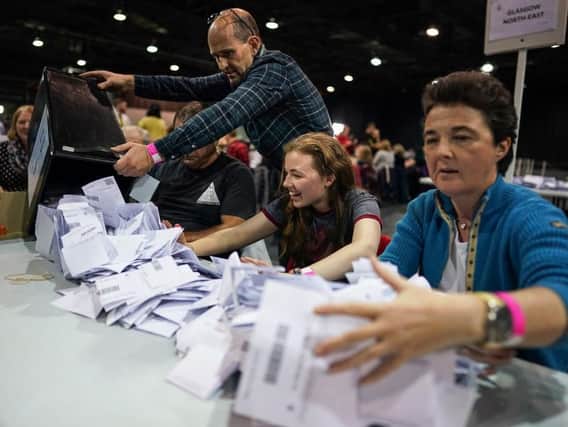 Staff members empty a ballot box at the main Glasgow counting centre in the SECC on 12 December 2019 (Photo: Jeff J Mitchell/Getty Images)