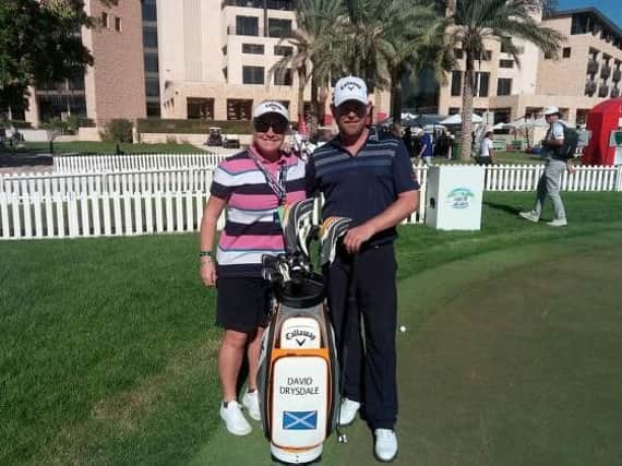David Drysdale, pictured with his wife and caddie Vicky, opened with a two-under-par 70 in the Abu Dhabi HSBC Championship