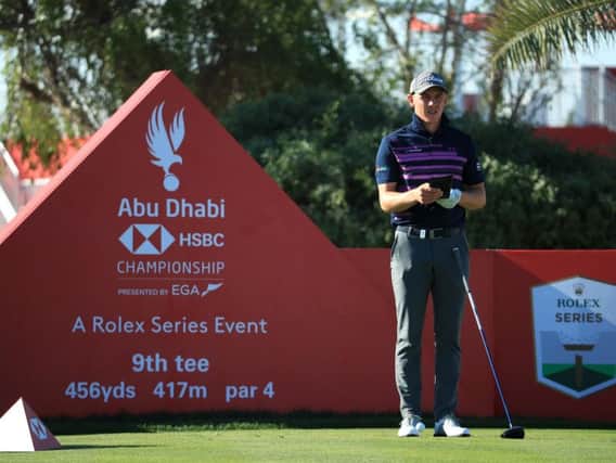 Grant Forrest checks his yardage book during the second round of the Abu Dhabi HSBC Championship