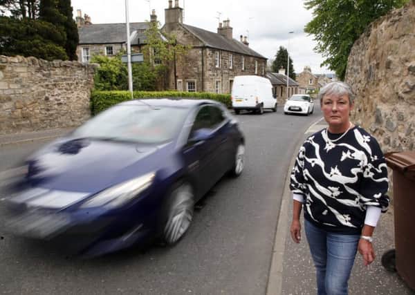 Resident Fiona Gilbert  next to a busy road in Bonnyrigg